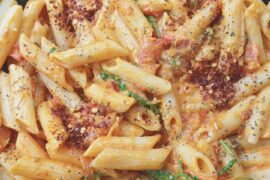 Penne pasta with caramelized onions, cheese, and mashed vegetables