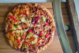 "Homefrozen" reheated pan pizza with peperoni, the vegtable and bell pepper.