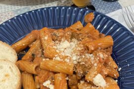 Rigatoni with creamy tomato-zucchini-pancetta sauce and parmesan cheese
