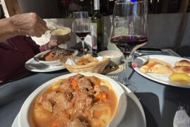 Sorrentinos (giant stuffed pasta) topped with beef stew