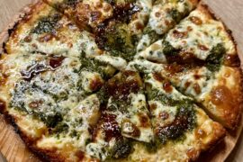 Homemade cast iron pizza with handmade pesto, fresh mozzarella, & fig spread