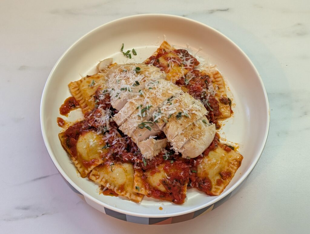 Spinach and ricotta ravioli with tomato and oregano sauce served with a sous vide chicken breast.