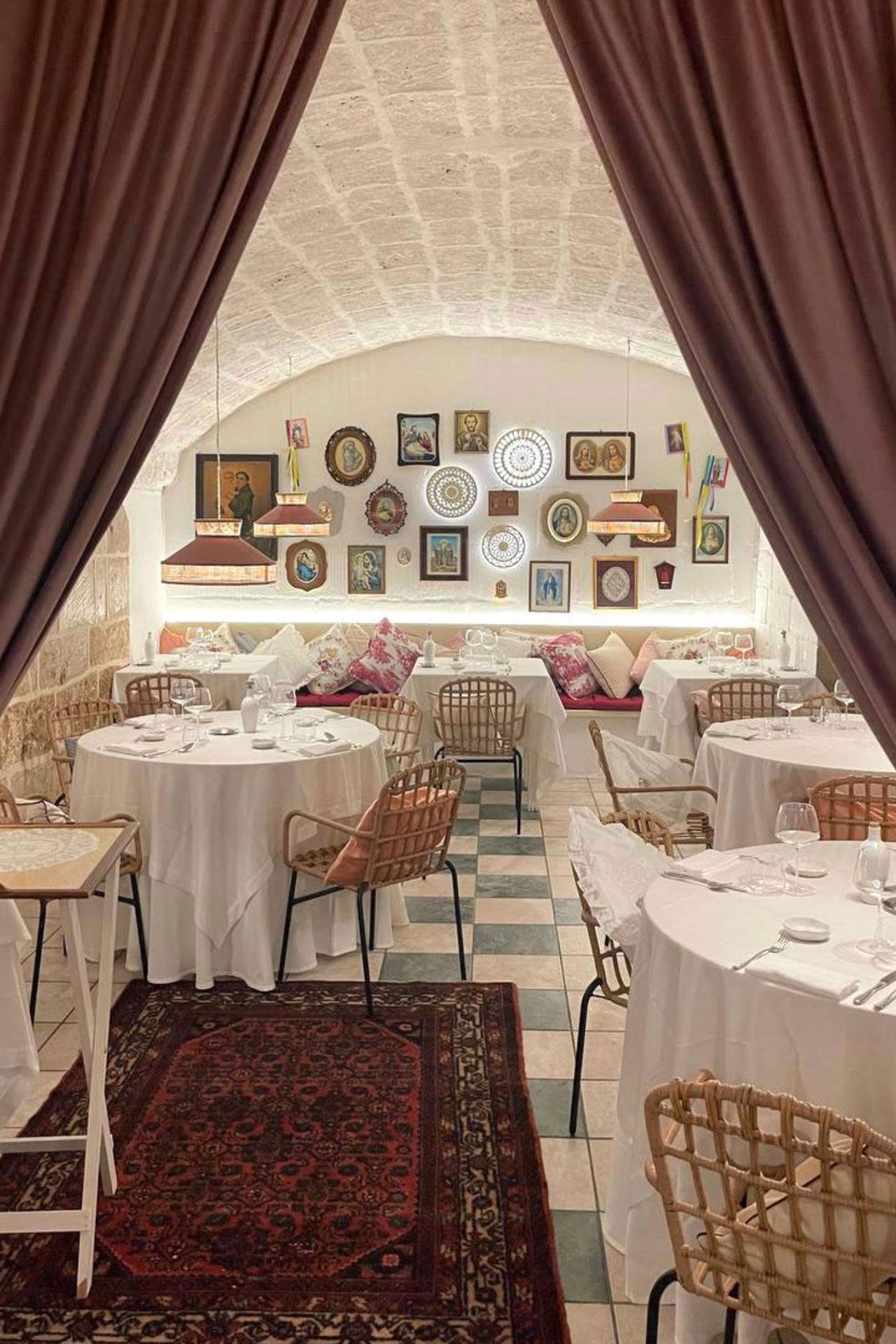 Image may contain Indoors Home Decor Rug Chair Furniture Cutlery Fork Hall Art Painting Person Fun and Banquet