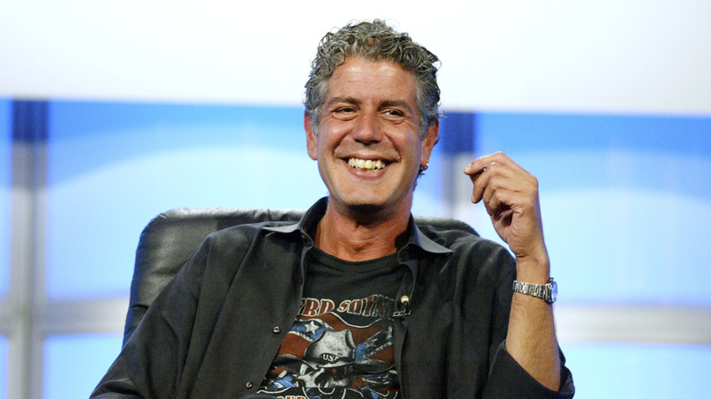Anthony Bourdain, seated and smiling.