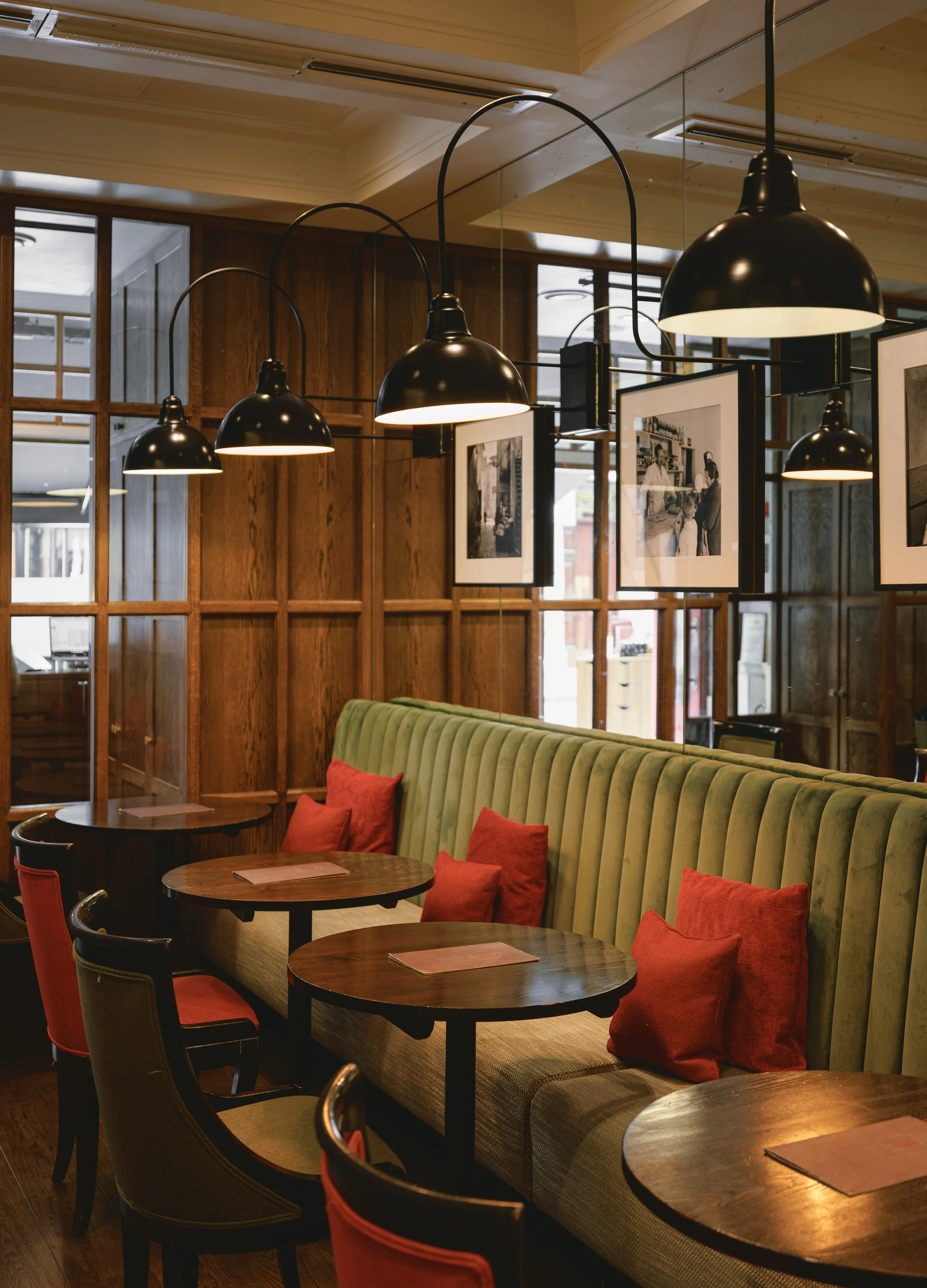 Green banquette seating with red cushions at Franco’s 