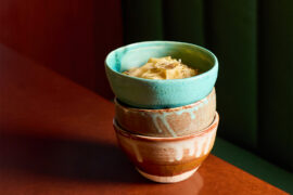 A stack of three bowls with cacio e pepe ramen inside