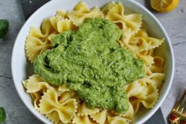 pasta in bowl with green basil avocado pesto in the middle