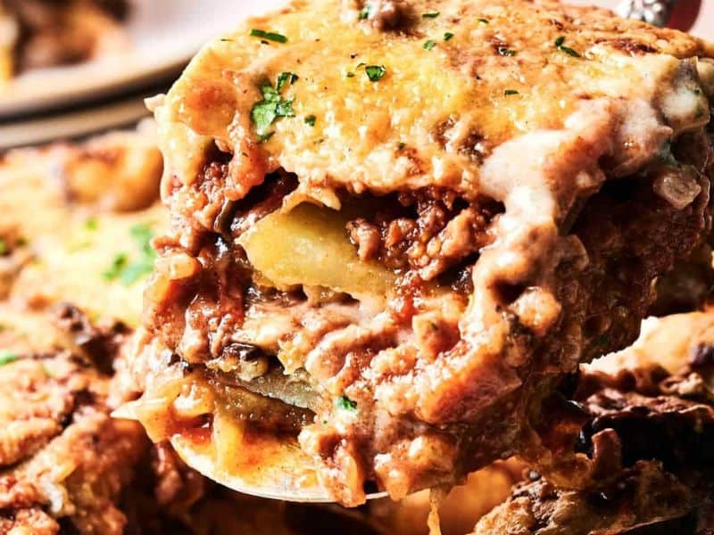 Beef moussaka with browned cheese and layered vegetables.