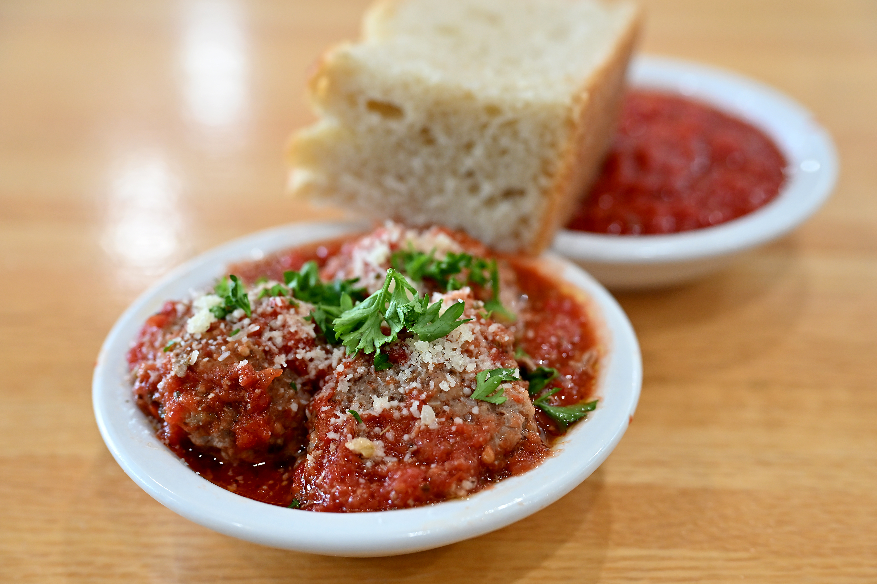 A side of house-made meatballs and focaccia bread. Basilwood Kitchen, a locally owned Italian restaurant and market specializing in fresh-made pasta and other foods, recently opened in Edgewater. (Paul W. Gillespie/Staff photo)