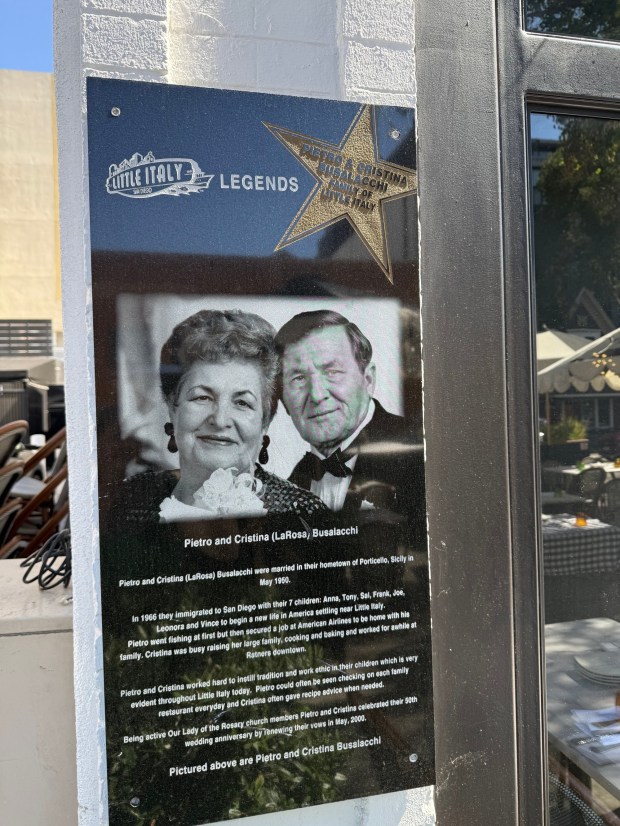 A plaque outside a restaurant owned by the Busalacchi family talks about the first-generation immigrants who settled in San Diego in 1966. (Roxana Popescu / The San Diego Union-Tribune)